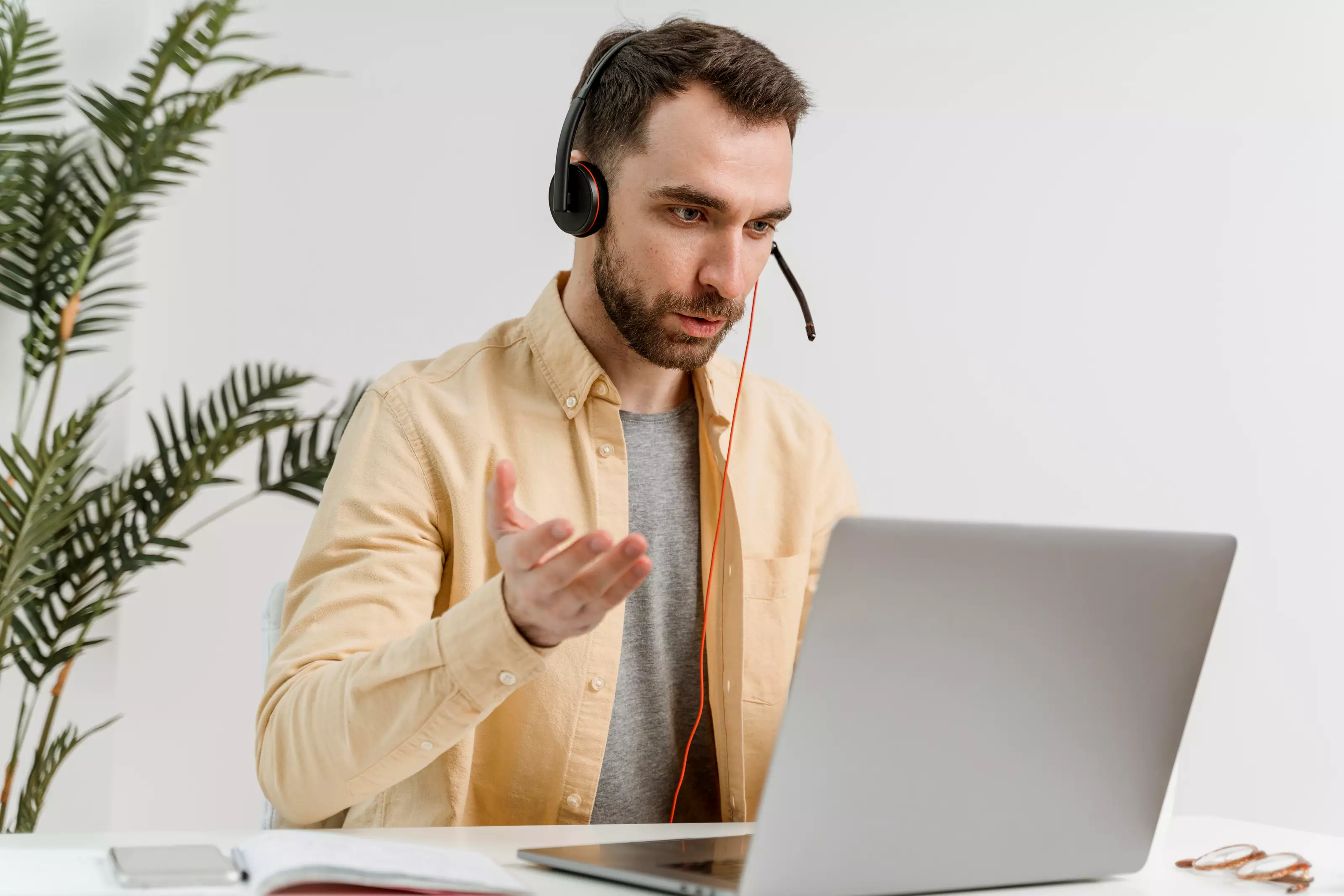 man-headset-having-video-call-laptop_101