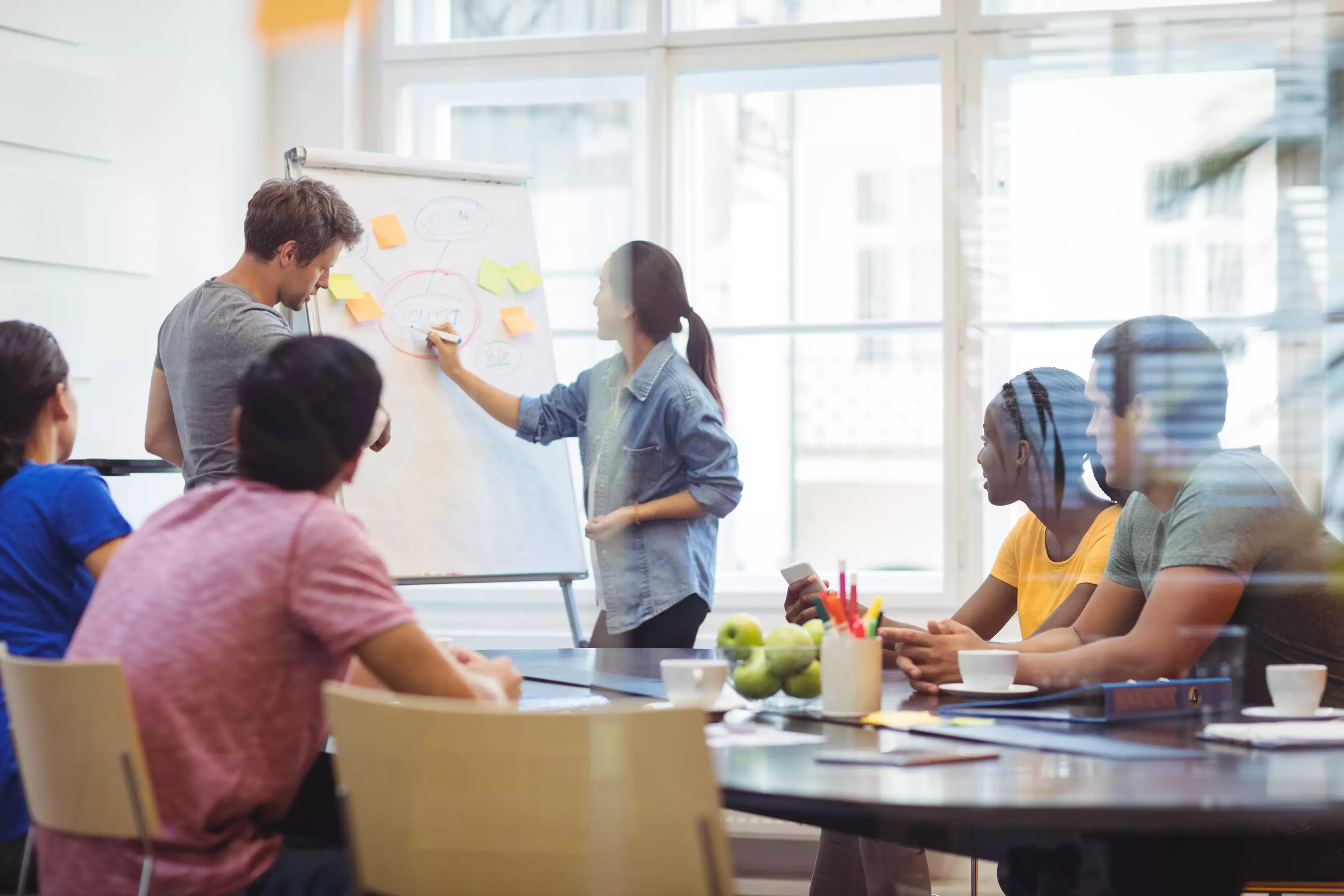 business-leaders-discussing-with-their-colleagues-whiteboa_235